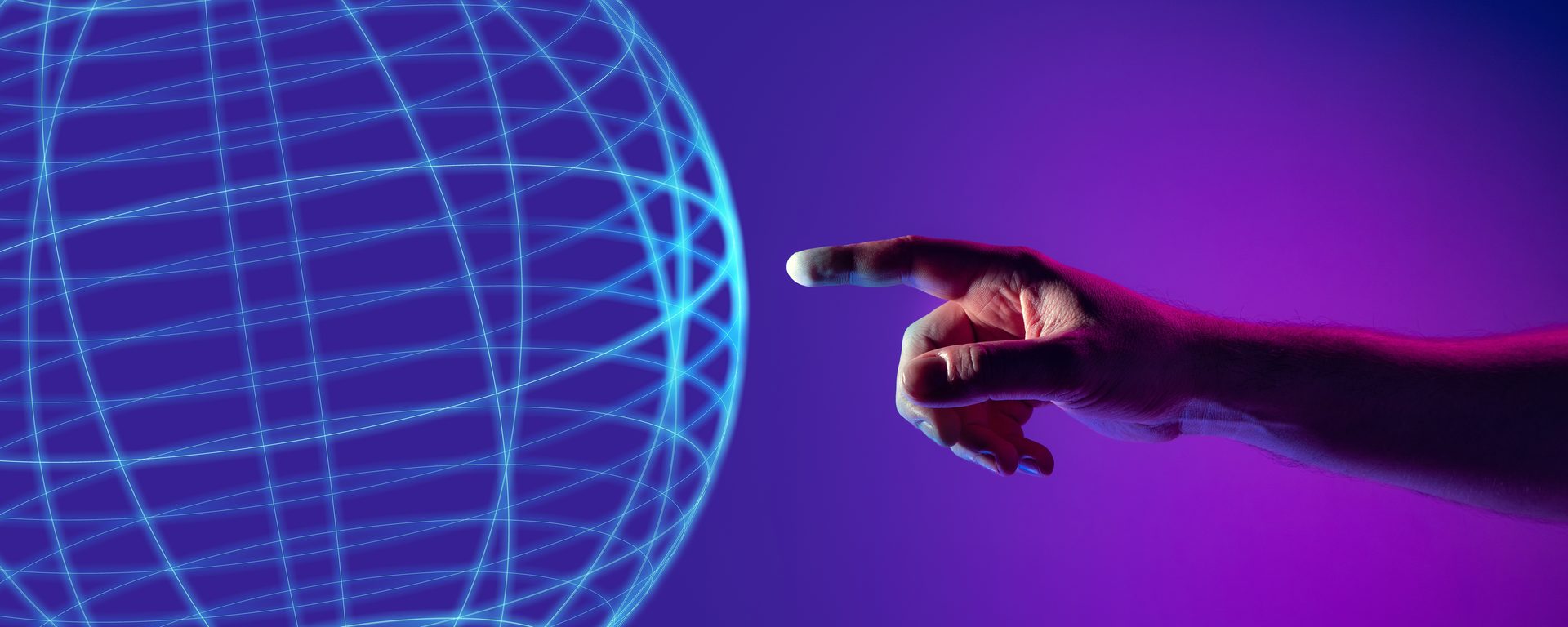 Hand pointing at a glowing wireframe globe