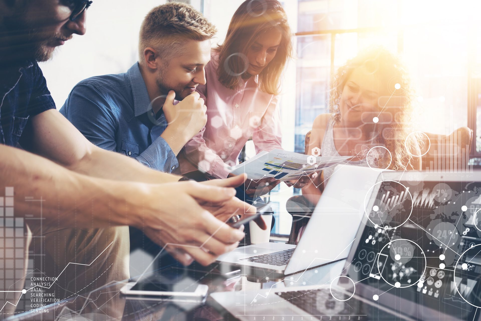 Marketing team around a laptop with a digital overlay